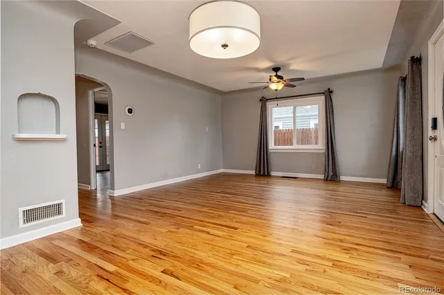 wooden floor in an empty room with a window