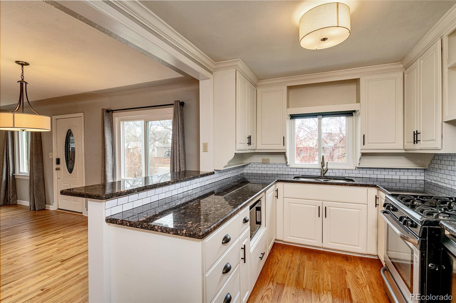 1250 Emporia Street Aurora, CO 80010 - Photo 2 of 33 a kitchen with granite countertop a sink a counter space appliances and cabinets