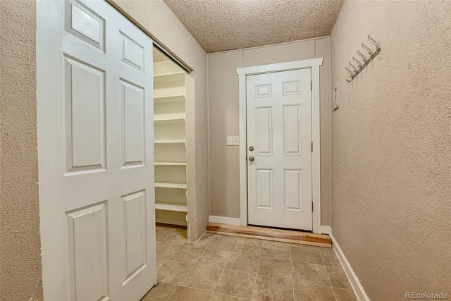 a view of an empty room with closet area