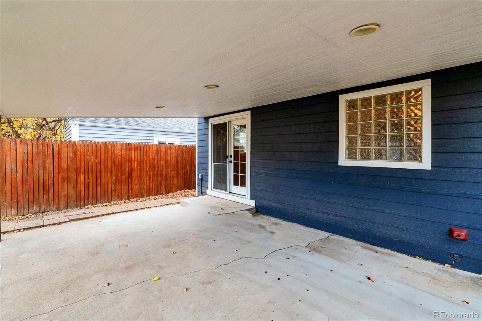 1250 Emporia Street Aurora, CO 80010 - Photo 25 of 33 a view of an empty room with wooden floor and a window
