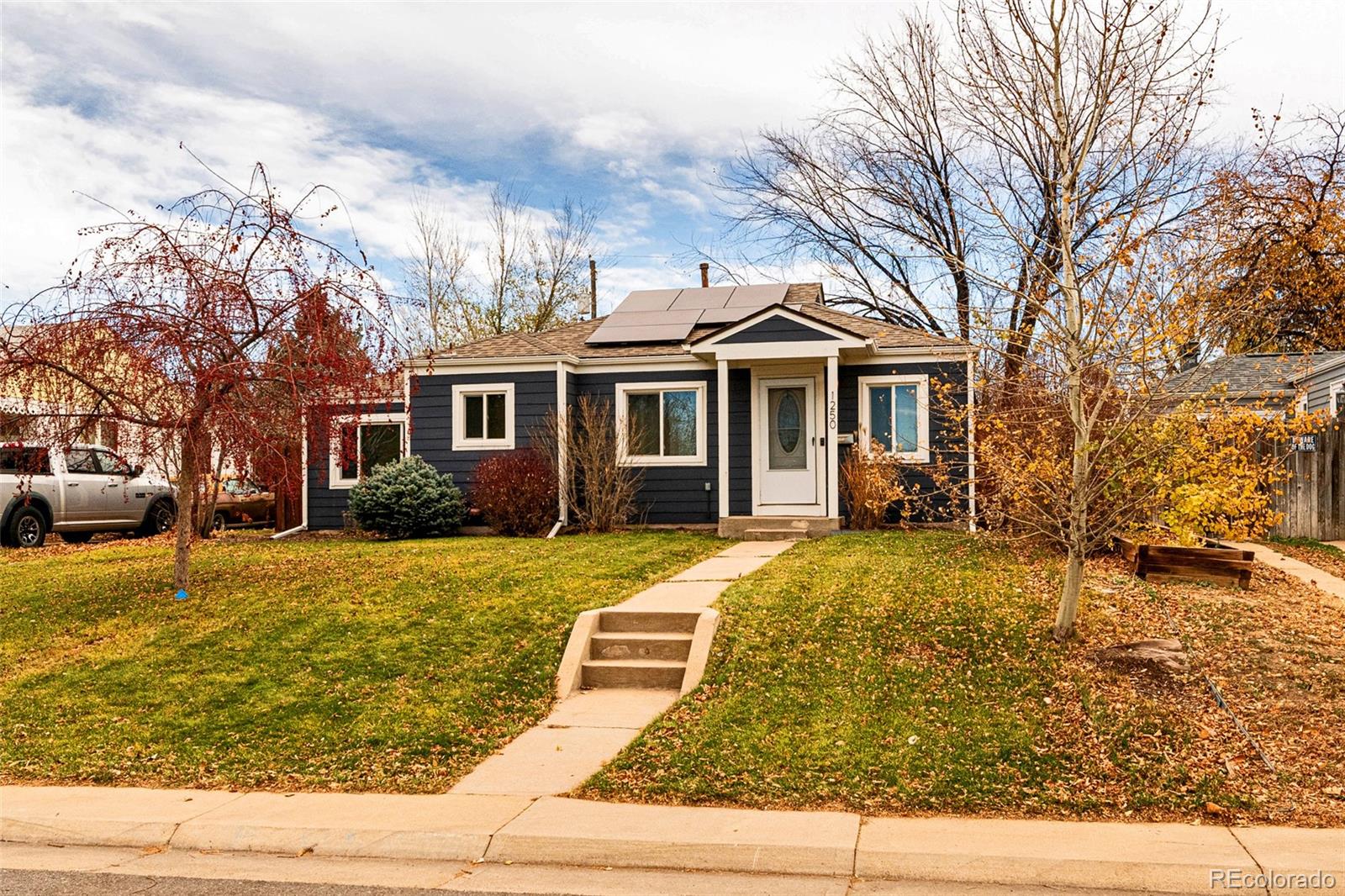 1250 Emporia Street Aurora, CO 80010 - Photo 31 of 33 a front view of a house with a yard