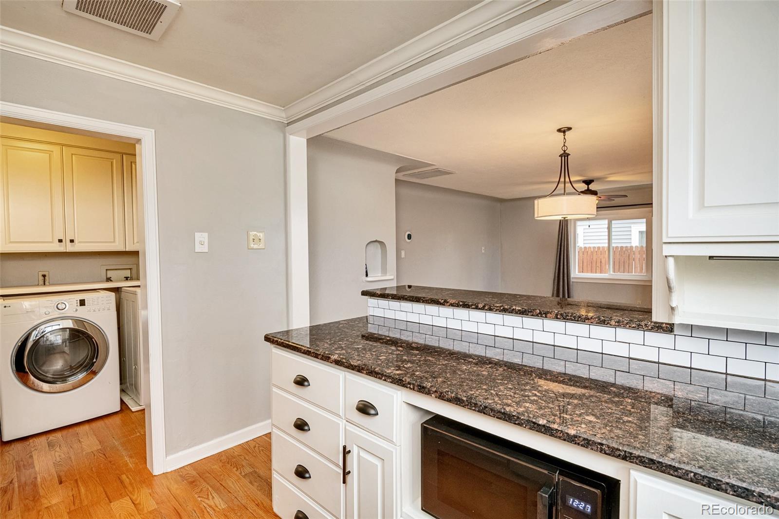 1250 Emporia Street Aurora, CO 80010 - Photo 4 of 33 a view of a kitchen cabinets and a counter place