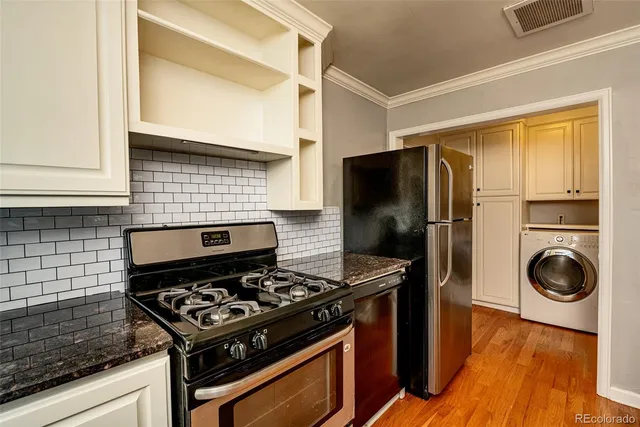 a kitchen with a stove and a refrigerator