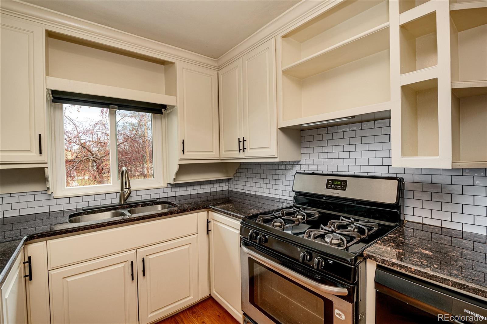 1250 Emporia Street Aurora, CO 80010 - Photo 9 of 33 a kitchen with a stove a sink and a window