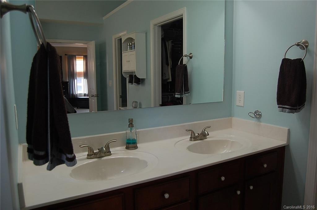 5831 Ringneck Road Charlotte, NC 28216 - Photo 13 of 20 a bathroom with a sink double vanity and a mirror