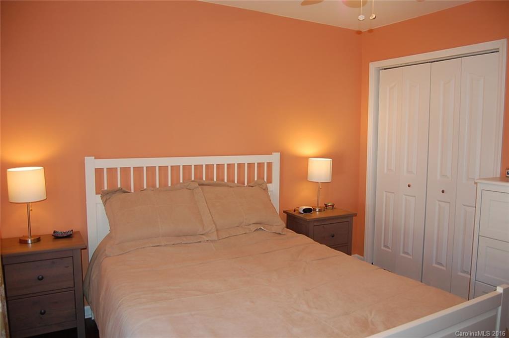 5831 Ringneck Road Charlotte, NC 28216 - Photo 15 of 20 a bedroom with a bed and a lamp on dresser