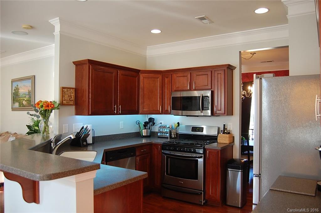 5831 Ringneck Road Charlotte, NC 28216 - Photo 3 of 20 a kitchen with stainless steel appliances granite countertop a sink stove and refrigerator
