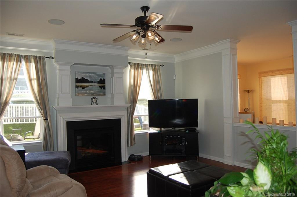 5831 Ringneck Road Charlotte, NC 28216 - Photo 6 of 20 a living room with furniture a fireplace and a flat screen tv