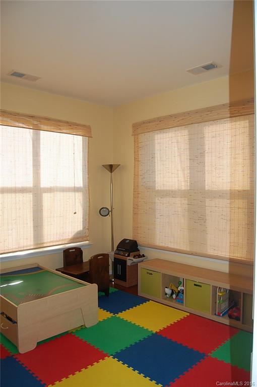 5831 Ringneck Road Charlotte, NC 28216 - Photo 8 of 20 a bedroom with furniture and a large window