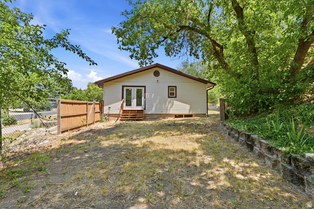 1410 Sumac Drive Logan, UT 84321 - Photo 26 of 28 Rear exterior featuring white horizontal siding and a brown-trimmed gable roof