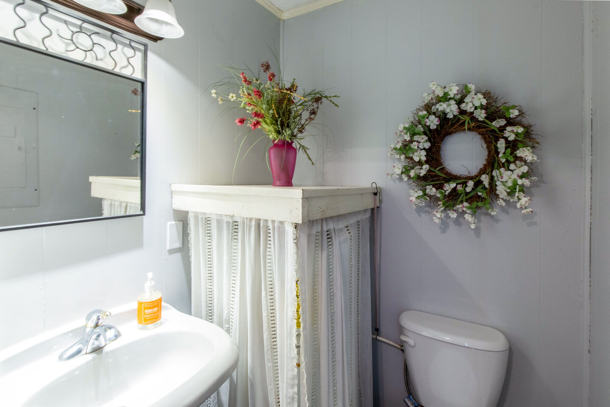 7813 Chester Road Fairview, TN 37062 - Photo 15 of 23 a bathroom with a toilet sink and mirror