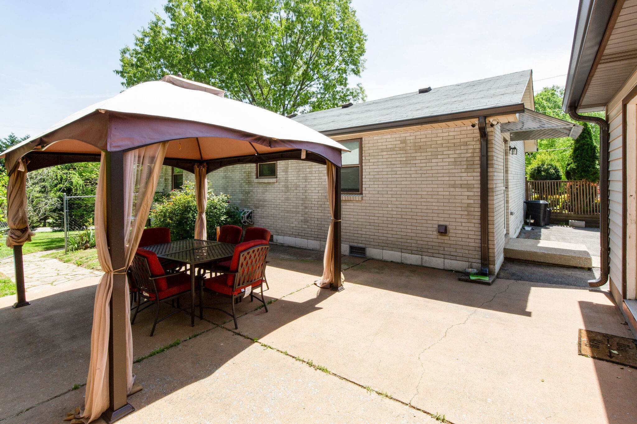 7813 Chester Road Fairview, TN 37062 - Photo 20 of 23 a view of a patio with table and chairs under an umbrella