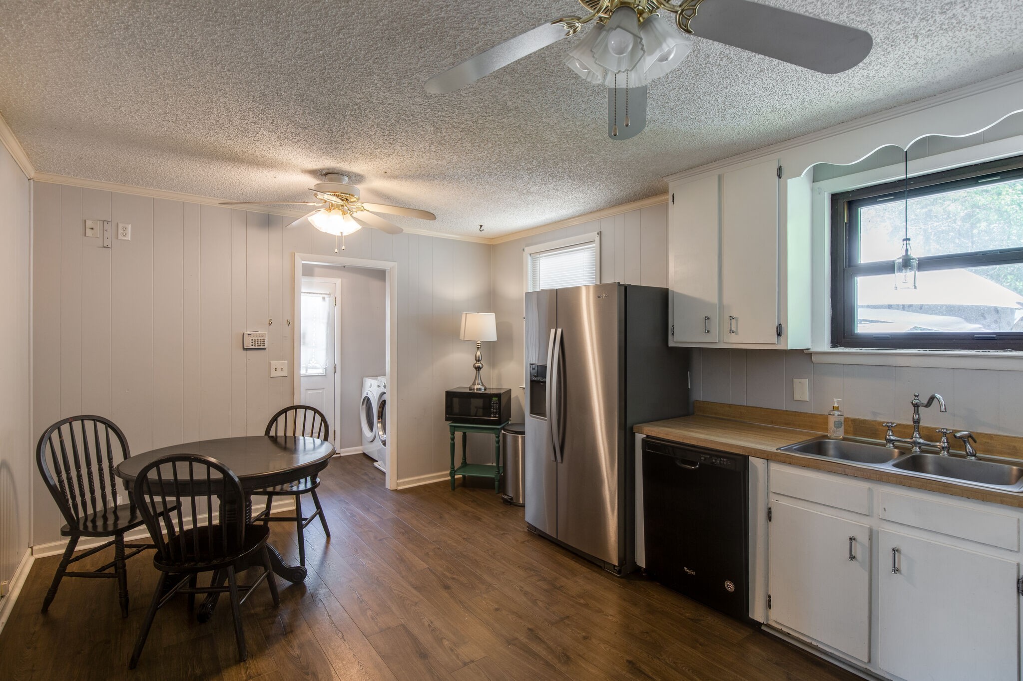 7813 Chester Road Fairview, TN 37062 - Photo 7 of 23 a kitchen with stainless steel appliances granite countertop a dining table chairs refrigerator and cabinets