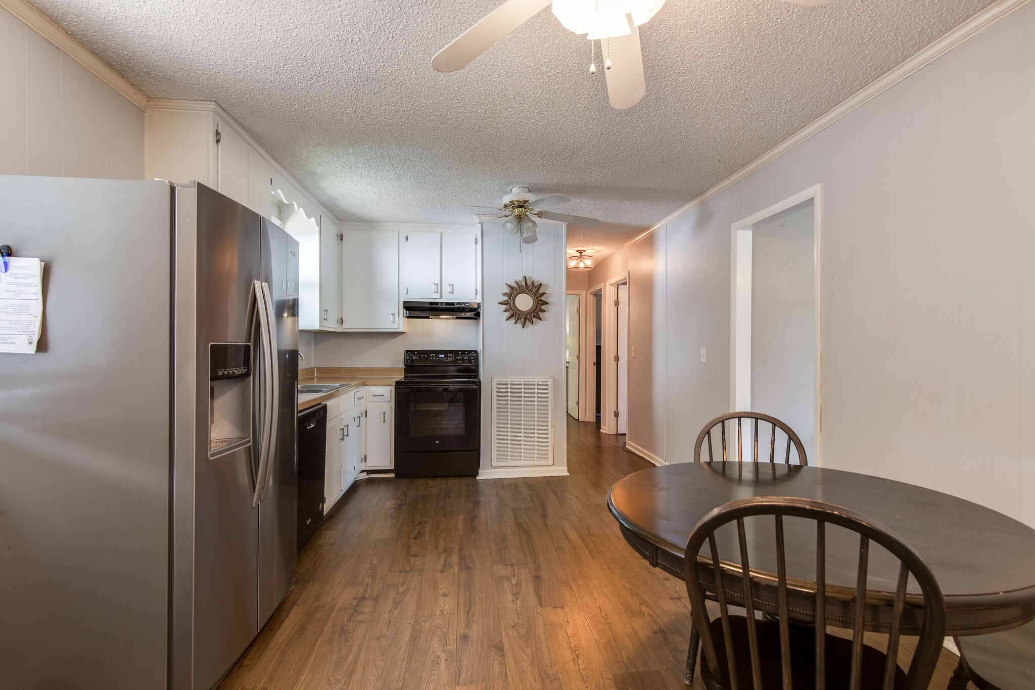 7813 Chester Road Fairview, TN 37062 - Photo 10 of 23 a kitchen with stainless steel appliances granite countertop a refrigerator a stove a sink dishwasher and a refrigerator with wooden floor
