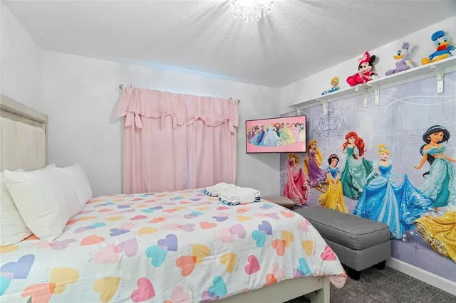 a bedroom with a bed and a chandelier