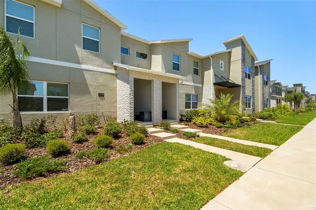 a view of a hallway with workspace and a window
