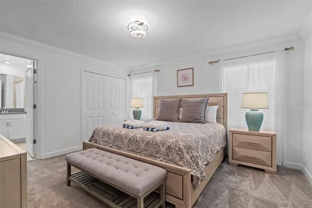 a kitchen with stainless steel appliances granite countertop a refrigerator a stove a kitchen island a dining table and chairs with wooden floor