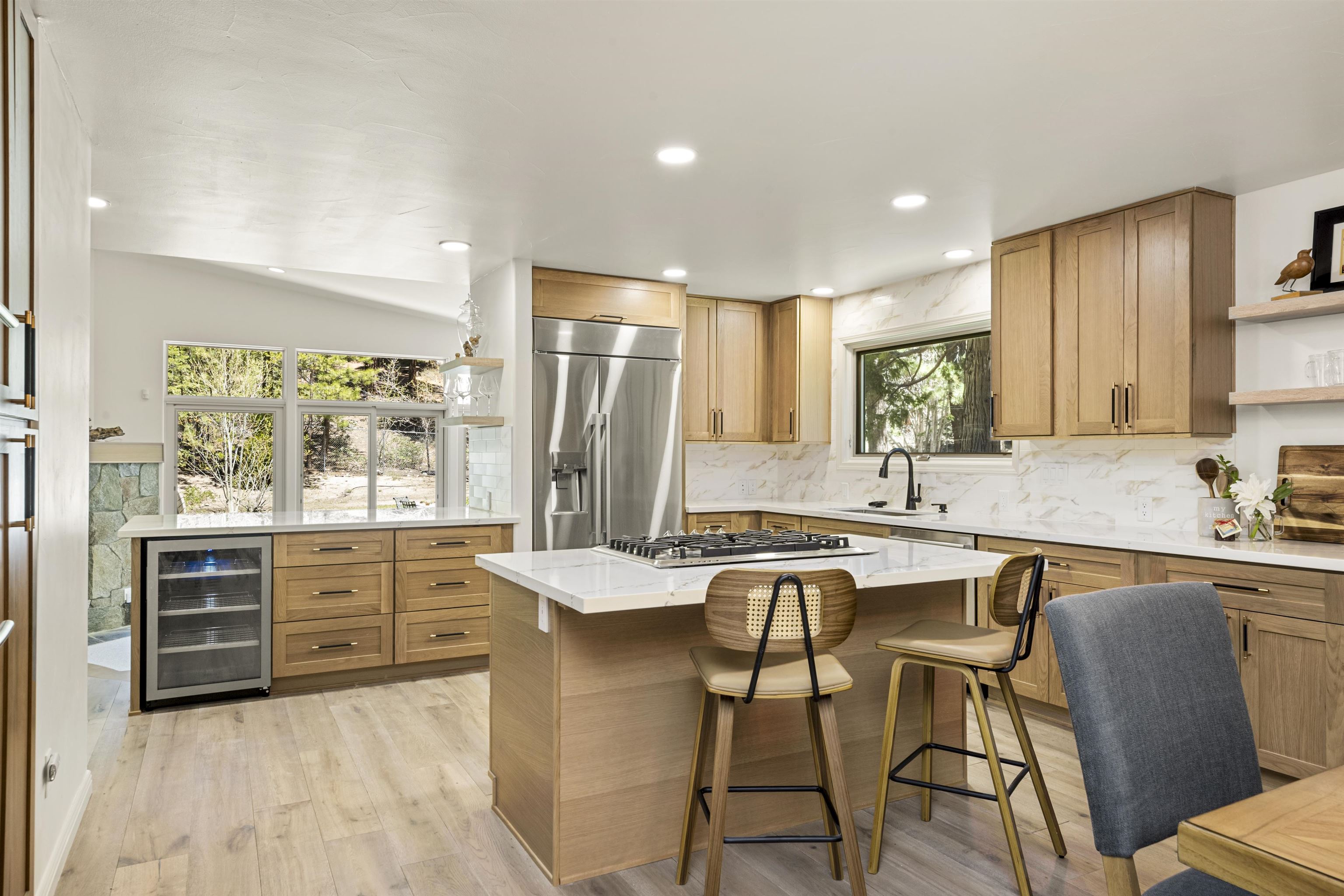 325 Winding Way Incline Village, NV 89451 - Photo 6 of 28 a kitchen with stainless steel appliances granite countertop a stove top oven a sink dishwasher a dining table and chairs with wooden floor