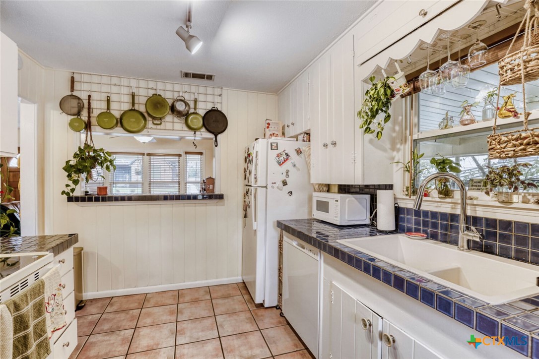 3307 Larry Lane Austin, TX 78722 - Photo 11 of 27 a kitchen with stainless steel appliances granite countertop a sink and a counter top space