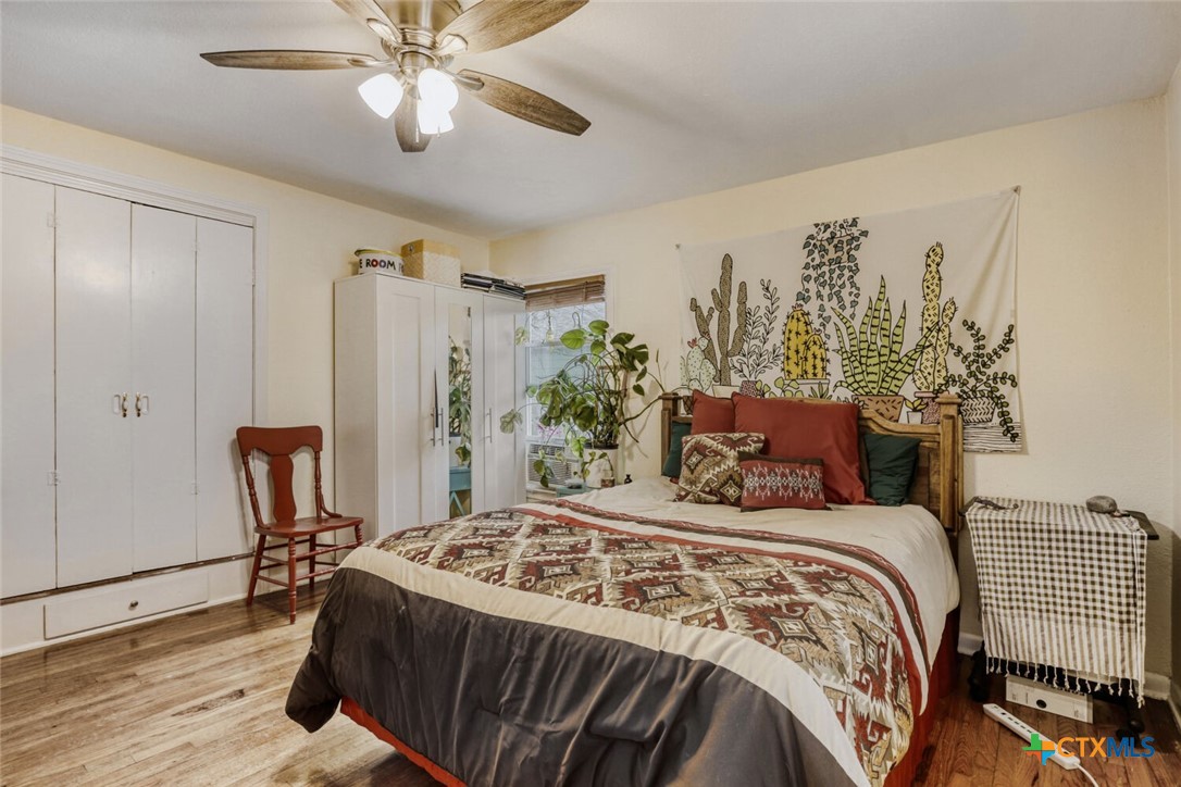 3307 Larry Lane Austin, TX 78722 - Photo 13 of 27 a bedroom with a large bed and a chandelier