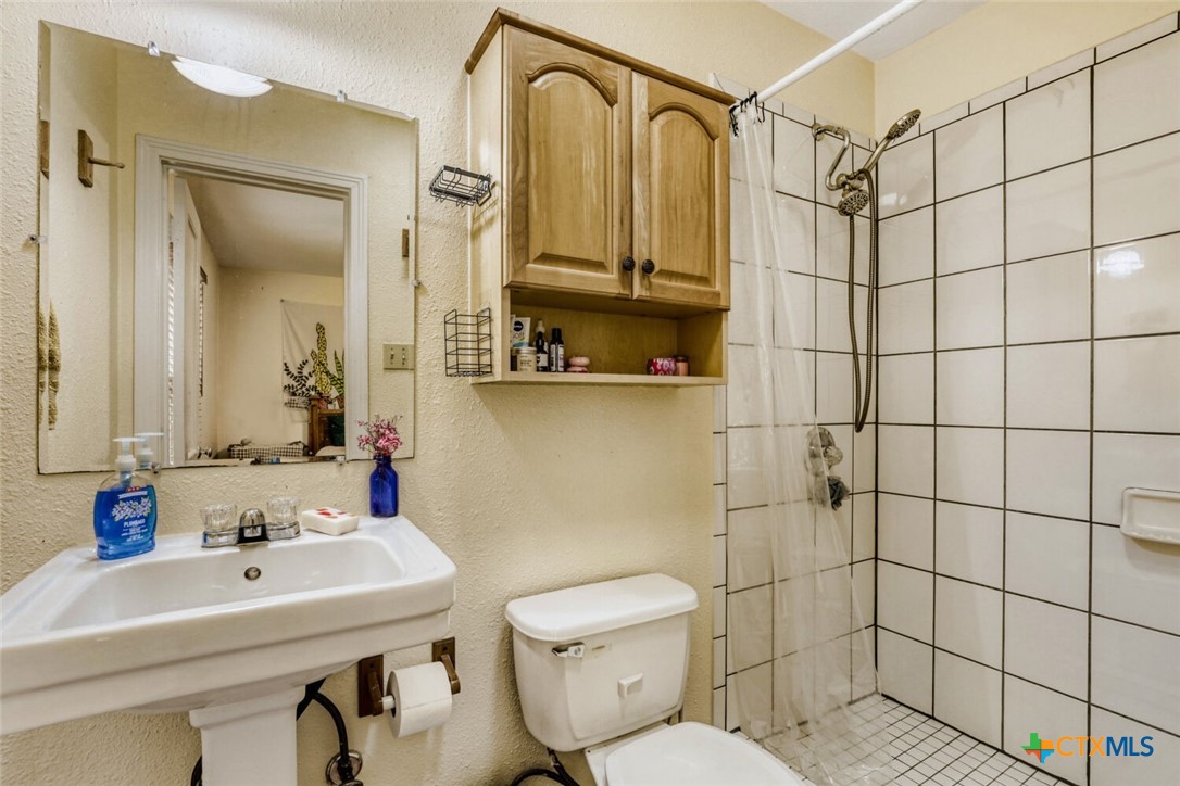 3307 Larry Lane Austin, TX 78722 - Photo 18 of 27 a bathroom with a sink toilet and shower