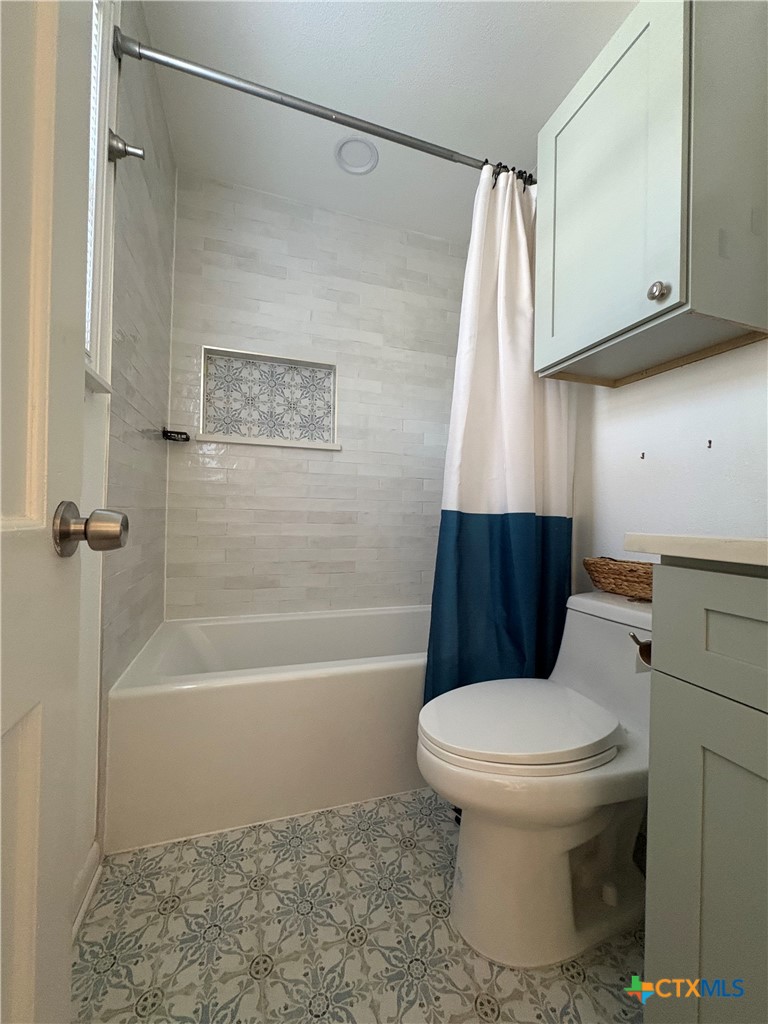 3307 Larry Lane Austin, TX 78722 - Photo 26 of 27 a bathroom with a toilet and a shower
