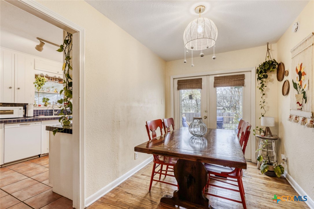 3307 Larry Lane Austin, TX 78722 - Photo 6 of 27 a view of a dining room with furniture window and wooden floor