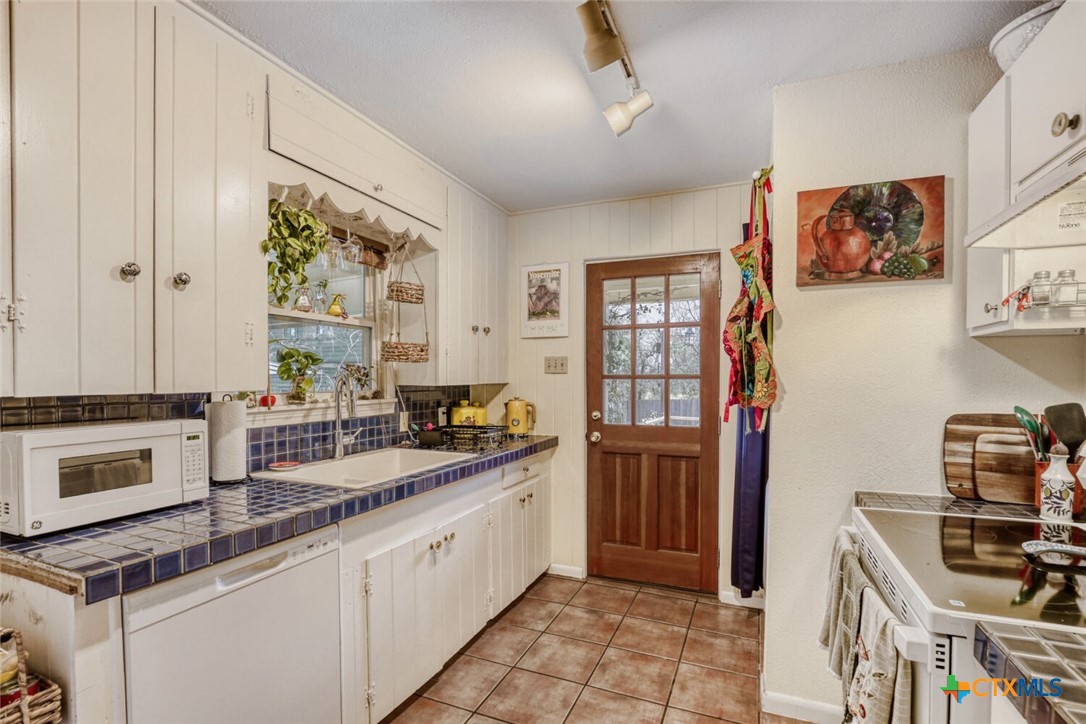 3307 Larry Lane Austin, TX 78722 - Photo 9 of 27 a kitchen with stainless steel appliances granite countertop a stove and cabinets