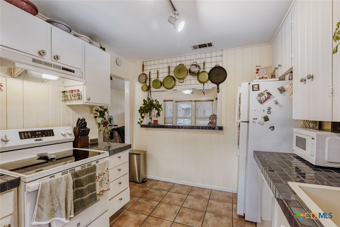 3307 Larry Lane Austin, TX 78722 - Photo 10 of 27 a kitchen with stainless steel appliances a sink and a refrigerator