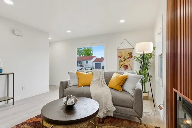 a living room with furniture and a lamp