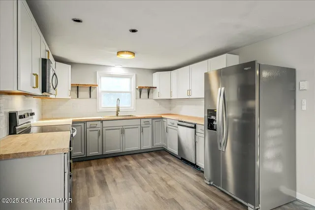 a kitchen with a refrigerator and a sink