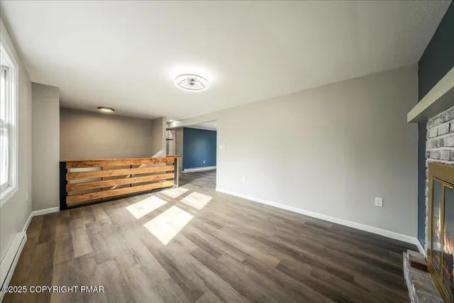 a view of room with wooden floor and window