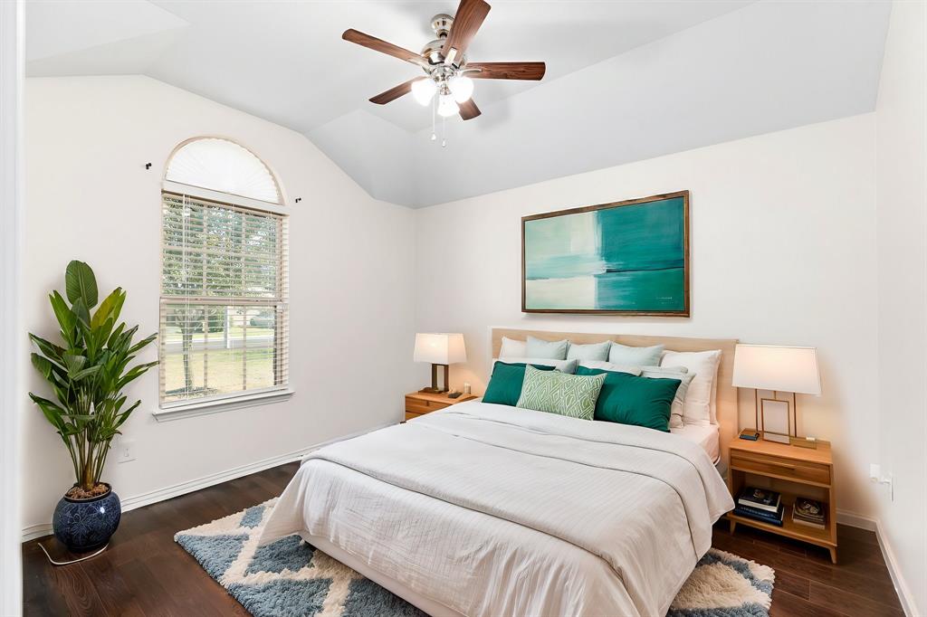 464 Evening Star Kyle, TX 78640 - Photo 6 of 8 Digital Staging. Hardwood flooring complements a bedroom with high vaulted ceilings and an arched window.