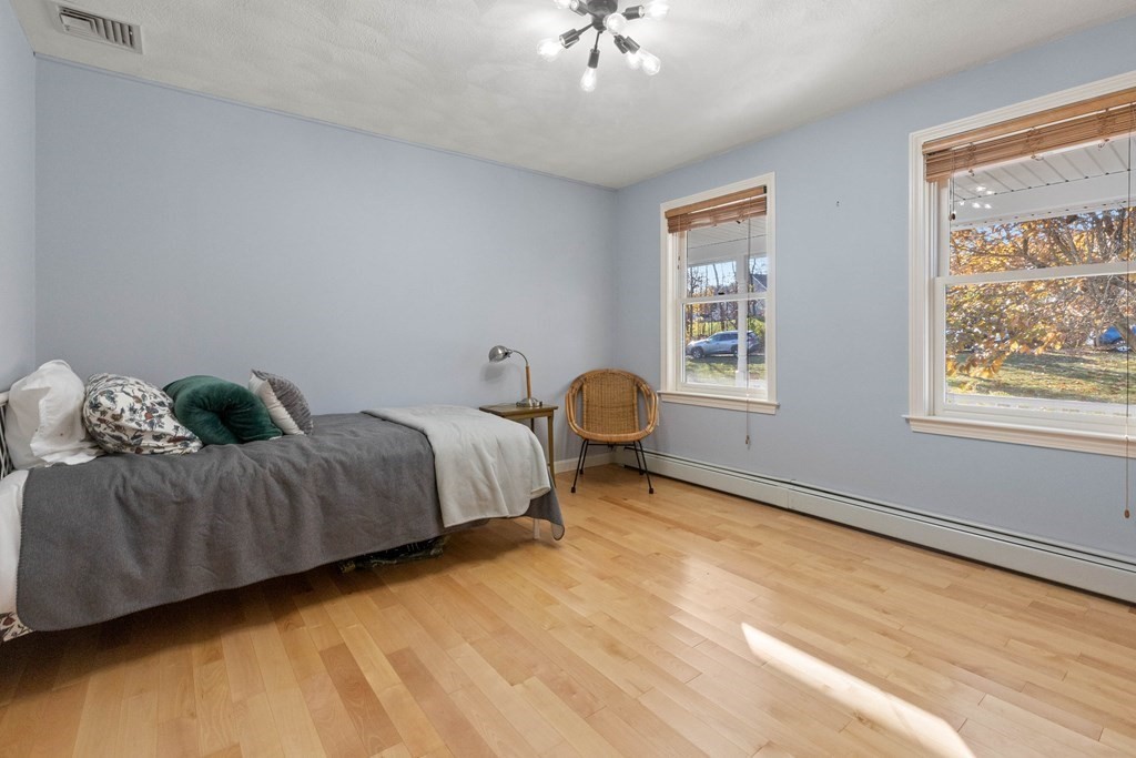 27 Brush Hill Road Merrimac, MA 01860 - Photo 8 of 26 a spacious bedroom with a bed and wooden floor