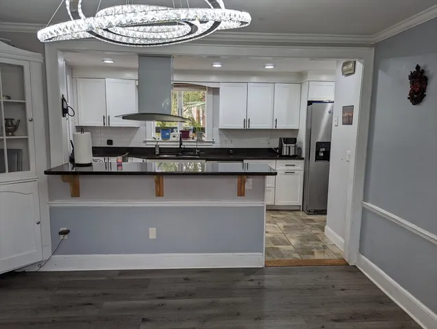 a kitchen with stainless steel appliances granite countertop a stove and a refrigerator