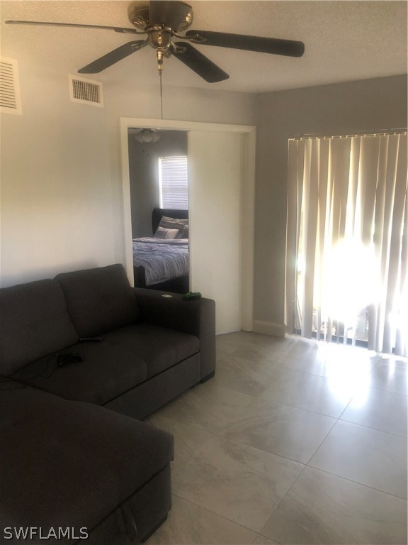 5325 Summerlin Road, Unit 2514 Fort Myers, FL 33919 - Photo 2 of 9 a living room with furniture and a large window