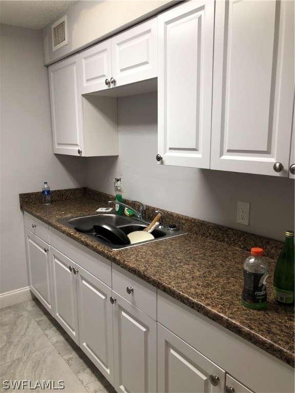 5325 Summerlin Road, Unit 2514 Fort Myers, FL 33919 - Photo 5 of 9 a kitchen with granite countertop a sink and cabinets