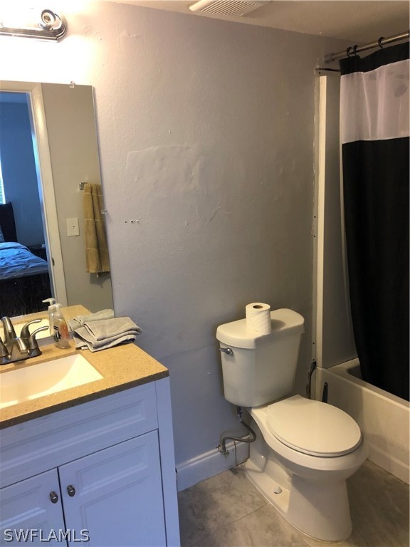 5325 Summerlin Road, Unit 2514 Fort Myers, FL 33919 - Photo 8 of 9 a bathroom with a toilet a sink and mirror