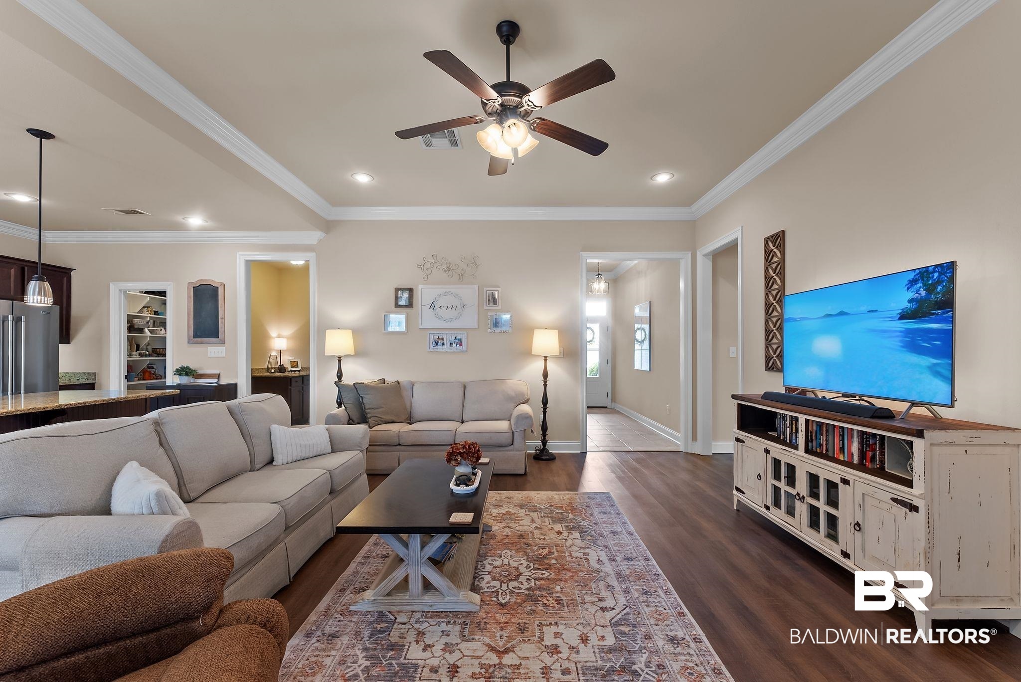 7015 Rocky Rd Loop Gulf Shores, AL 36542 - Photo 8 of 41 Living area featuring ornamental molding, ceiling fan, dark wood-type flooring, and recessed lighting