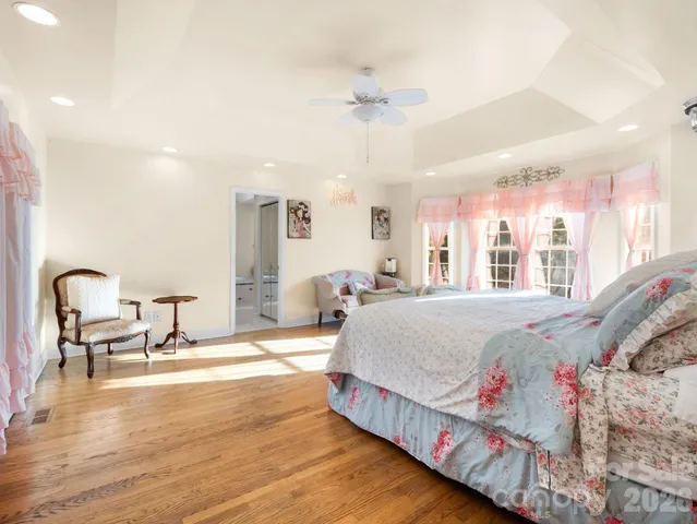 a bedroom with bed and a large window