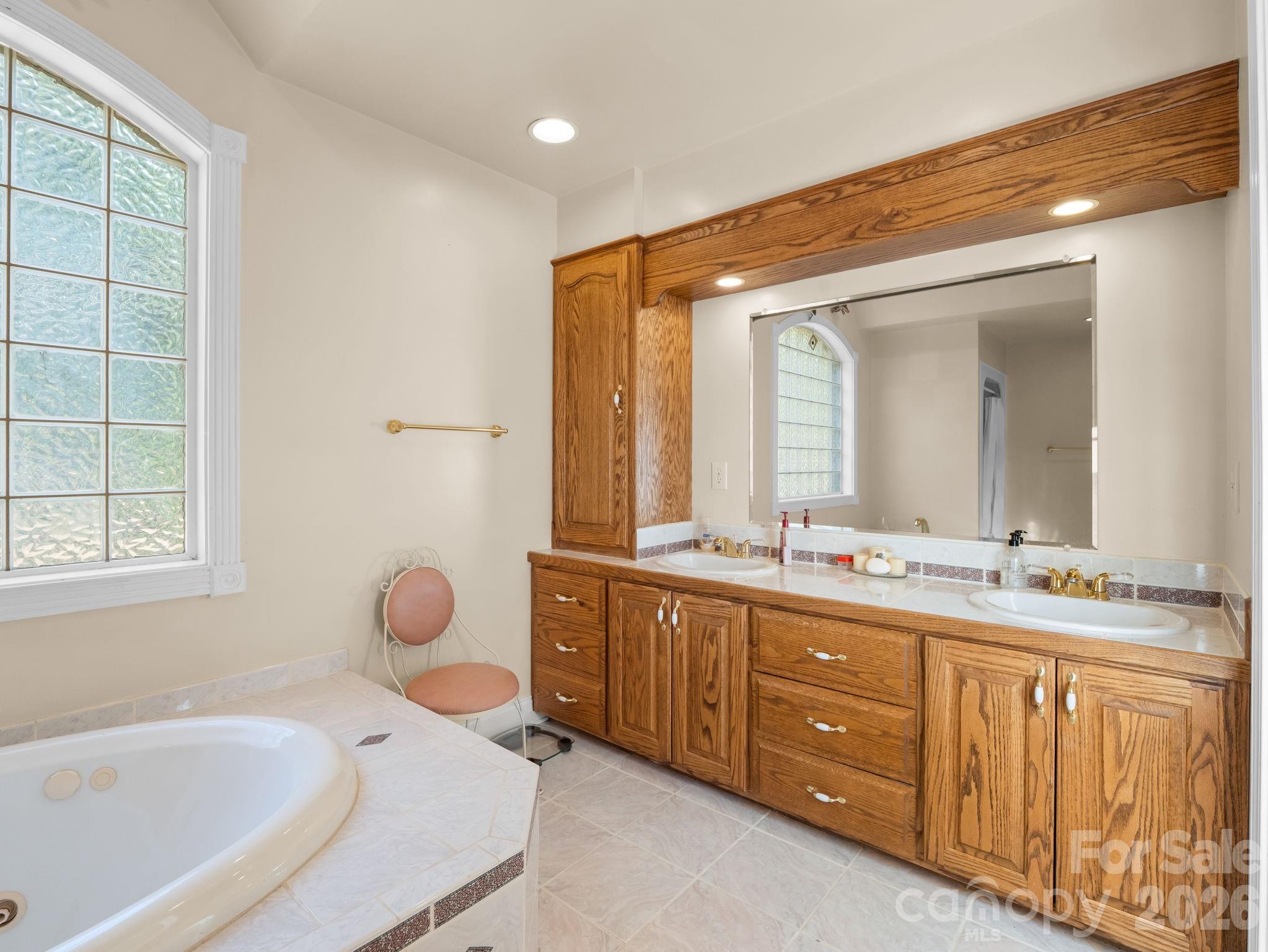 92 Rodaeo Drive Columbus, NC 28722 - Photo 16 of 32 a spacious bathroom with double vanity and a bathtub