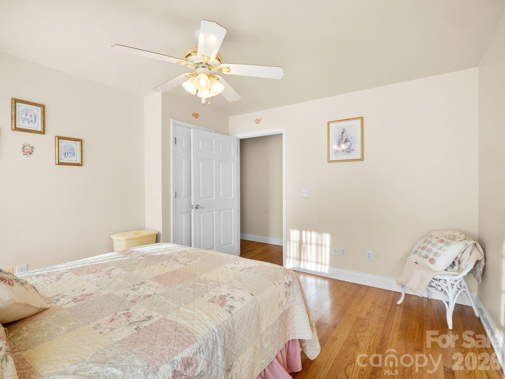 92 Rodaeo Drive Columbus, NC 28722 - Photo 19 of 32 a bedroom with a bed and a chandelier