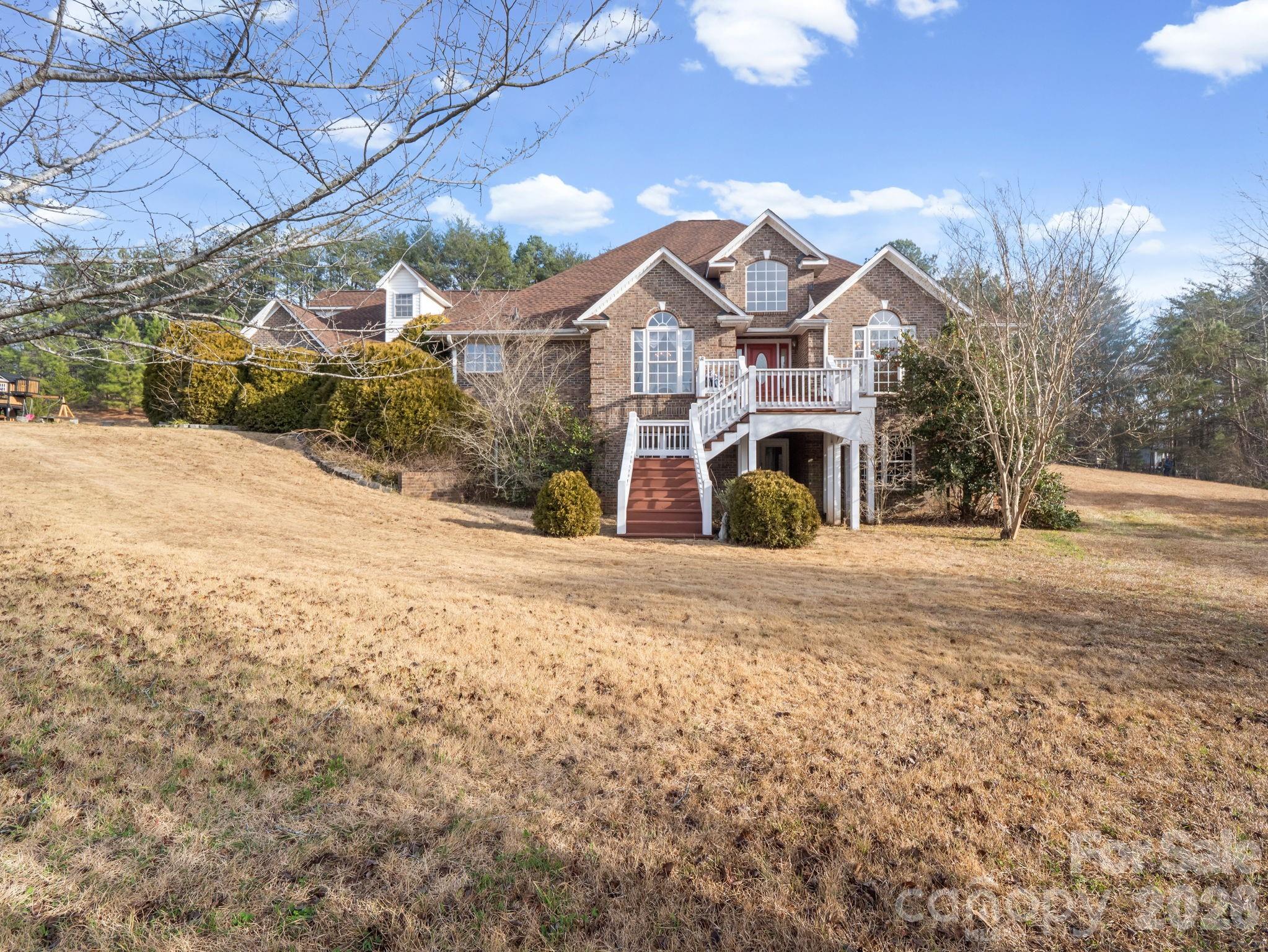 92 Rodaeo Drive Columbus, NC 28722 - Photo 2 of 32 a front view of a house with a yard