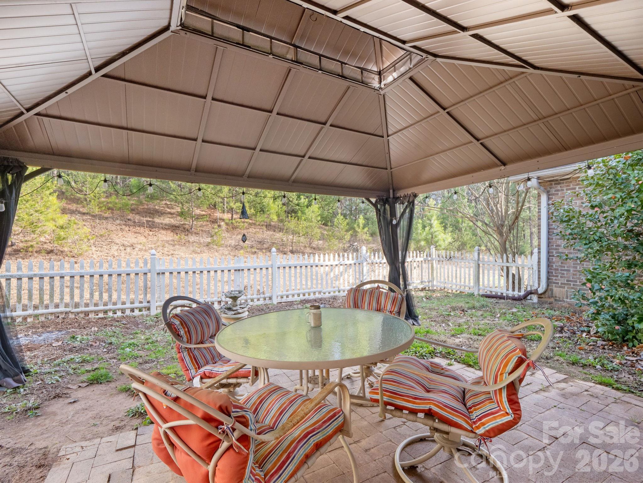 92 Rodaeo Drive Columbus, NC 28722 - Photo 21 of 40 a backyard of a house with yard table and chairs