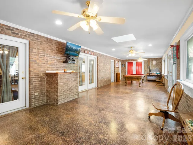 a view of a livingroom with furniture and a ceiling fan