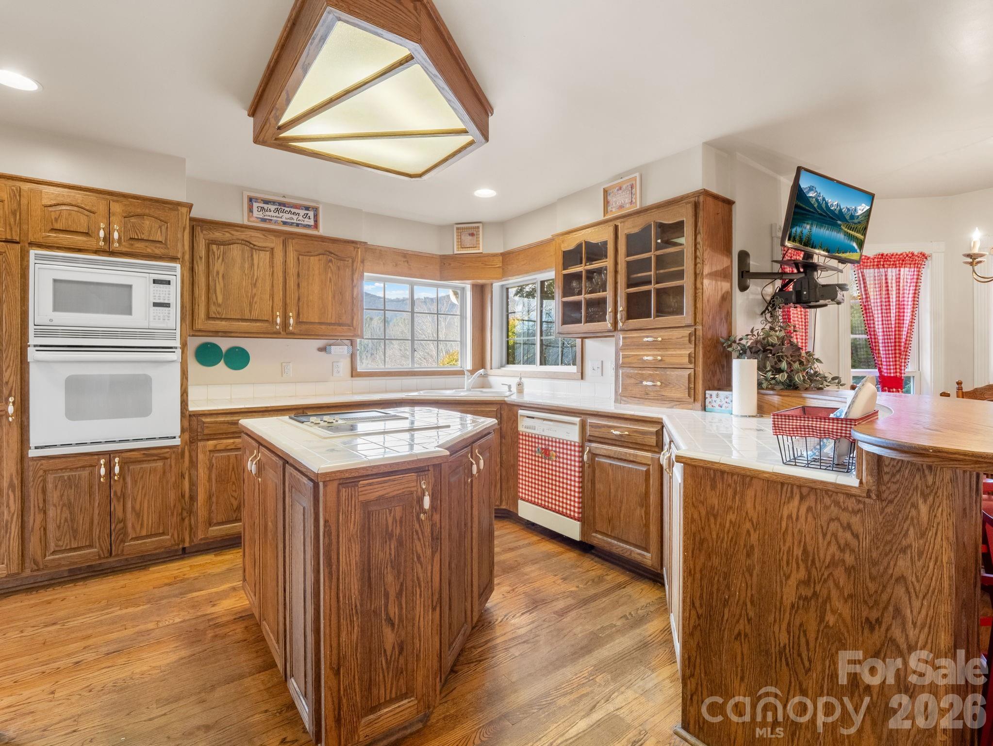 92 Rodaeo Drive Columbus, NC 28722 - Photo 23 of 40 a kitchen with stainless steel appliances granite countertop a stove and a sink