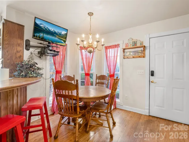 a view of a dining room with furniture and chandelier