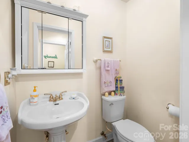 a bathroom with a sink mirror and toilet