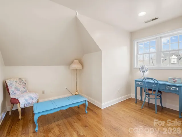 a view of a room with furniture and wooden floor