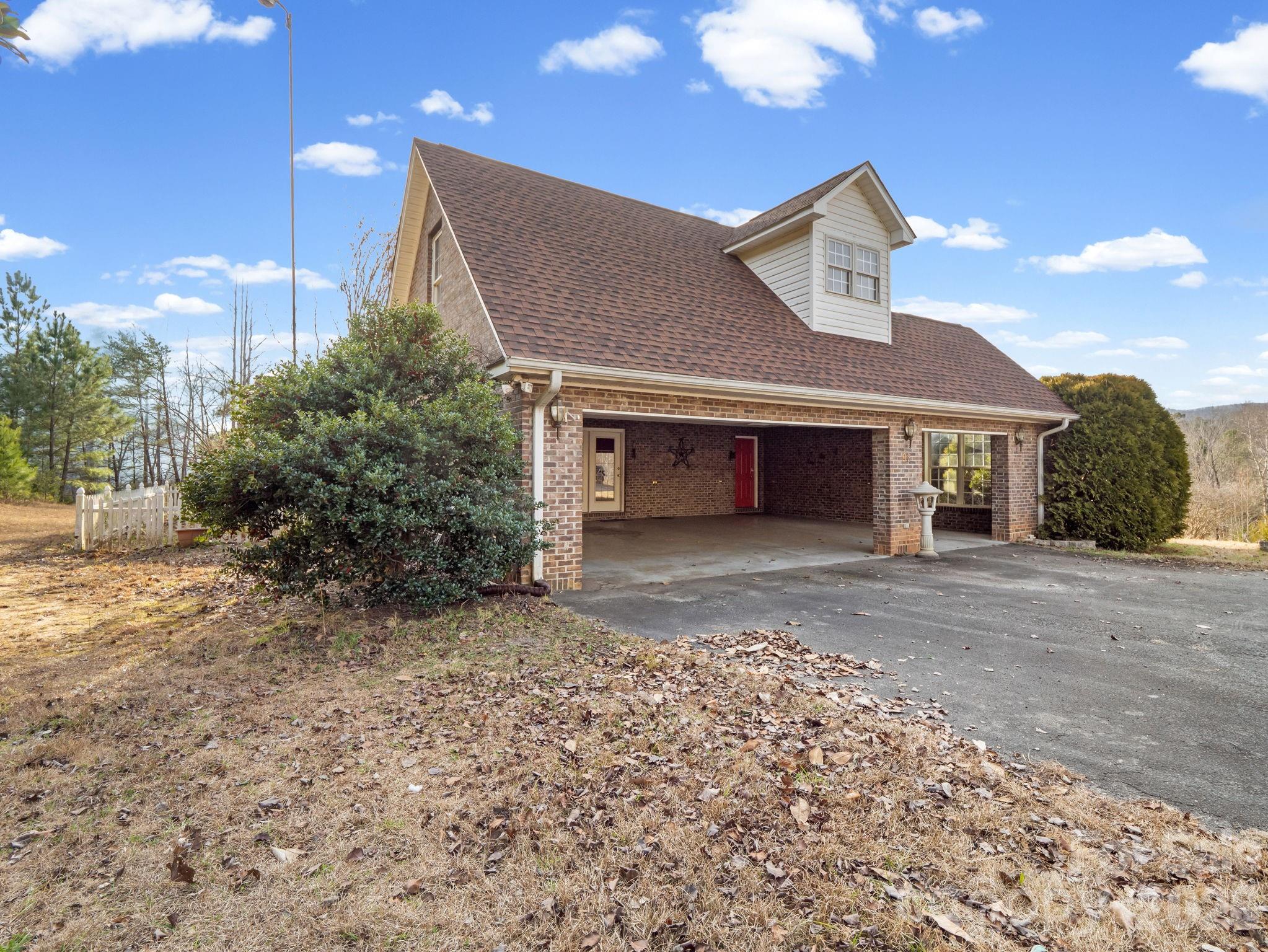 92 Rodaeo Drive Columbus, NC 28722 - Photo 7 of 32 a front view of a house with a yard and garage